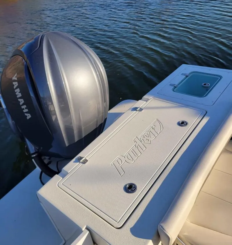 Slide: The Image of 2022 Parker 2320 SL Sport Cabin boat with Yamaha engine on water. - 8