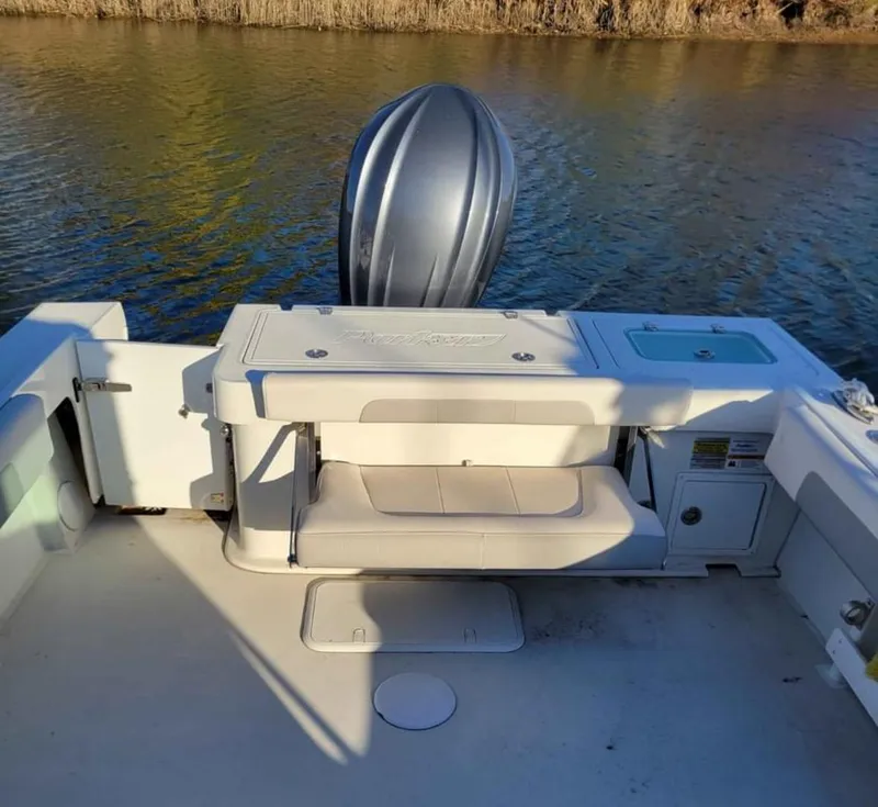 Slide: The Image of 2022 Parker 2320 SL Sport Cabin boat with outboard motor on calm water. - 9