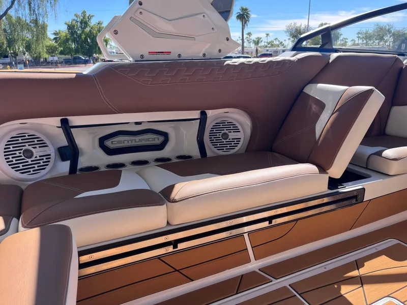 Slide: The Image of 2025 Centurion Ri245 boat interior with brown leather seats and built-in speakers. - 11
