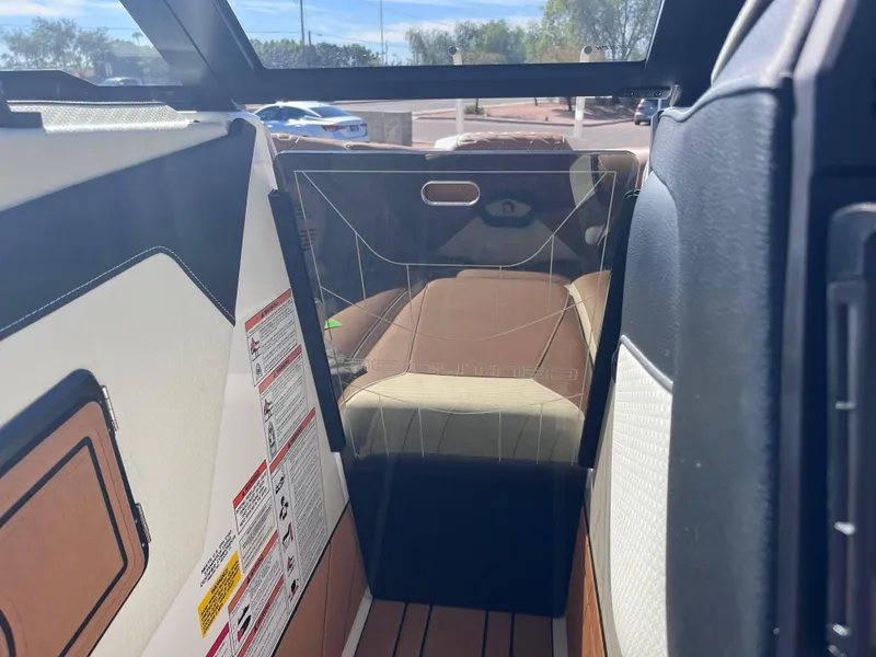 Slide: The Image of Interior view of 2025 Centurion Ri245 boat, featuring seating and safety instructions. - 12