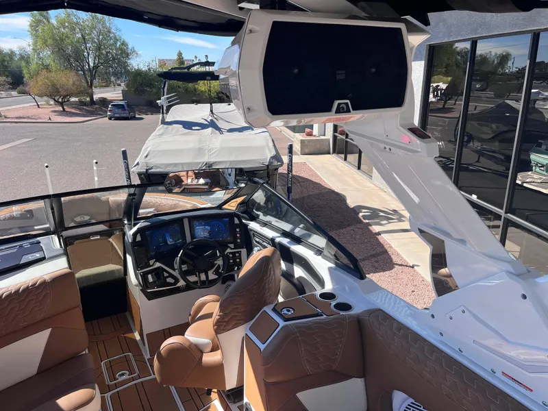 Slide: The Image of Interior of 2025 Centurion Ri245 boat with modern dashboard and seating. - 15