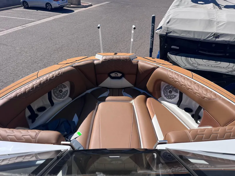 Slide: The Image of 2025 Centurion Ri245 boat interior with tan leather seating and built-in speakers. - 16