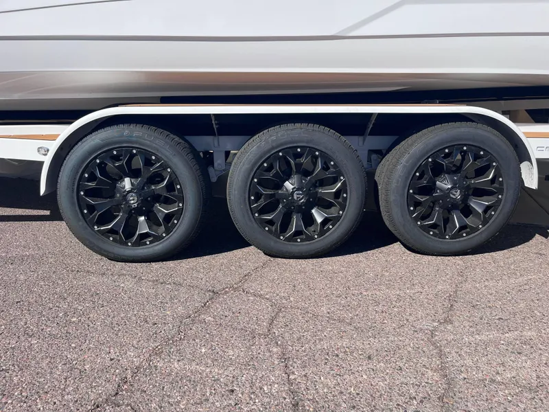 Slide: The Image of 2025 Centurion Ri245 boat trailer with three black alloy wheels. - 18