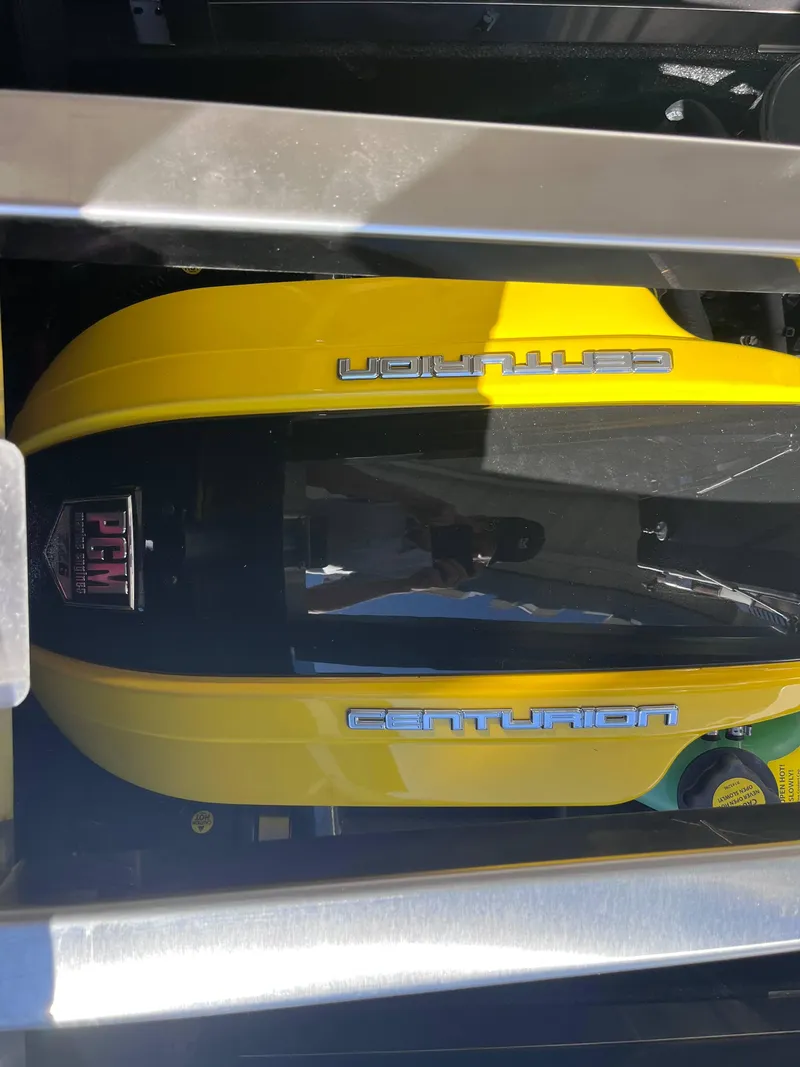 Slide: The Image of Yellow Centurion Ri245 engine cover, 2025 model, with PCM branding. - 19