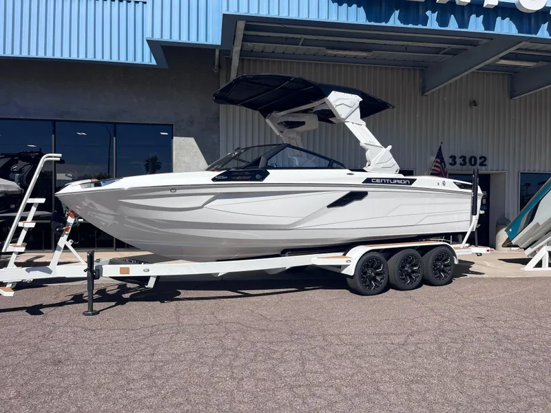 Slide: The Image of 2025 Centurion Ri245 boat on trailer outside dealership. - 3