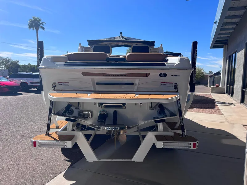 Slide: The Image of 2025 Centurion Ri245 boat rear view with swim platform in sunny outdoor setting. - 4