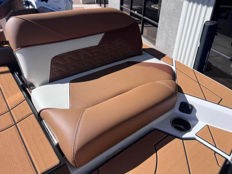 Slide: The Image of 2025 Centurion Ri245 boat seat with brown and white upholstery, cup holder, and modern design. - 5