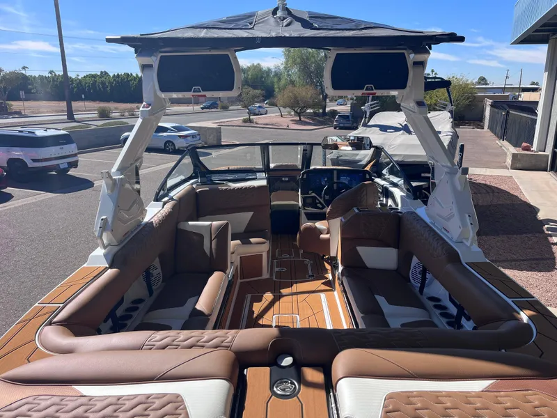 Slide: The Image of 2025 Centurion Ri245 boat interior with luxurious seating and modern dashboard. - 6