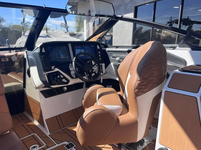 Slide: The Image of 2025 Centurion Ri245 boat interior with modern dashboard and luxurious seating. - 7