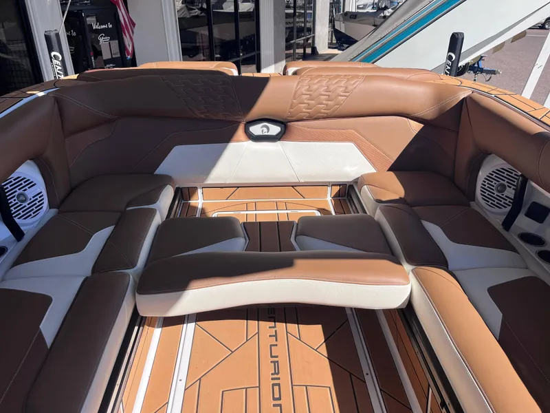 Slide: The Image of Luxurious interior of 2025 Centurion Ri245 boat with brown and white seating. - 8