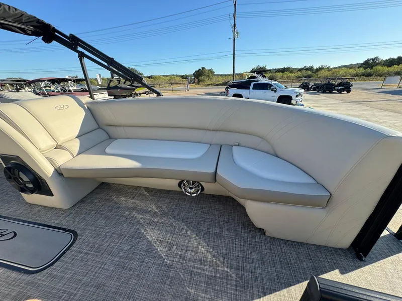 Slide: The Image of 2018 Harris Solstice 240 boat interior with beige seating and speaker system. - 11