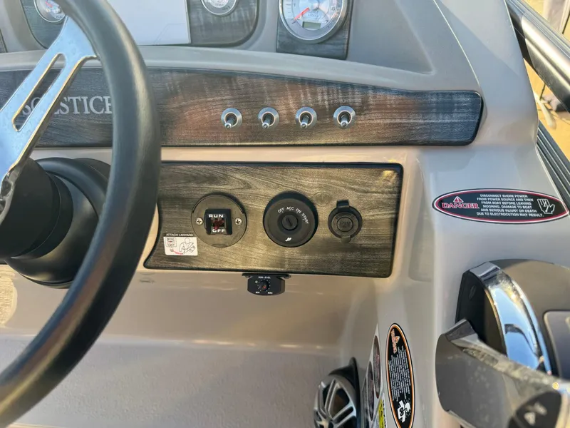 Slide: The Image of Control panel of 2018 Harris Solstice 240 boat with steering wheel and gauges. - 18
