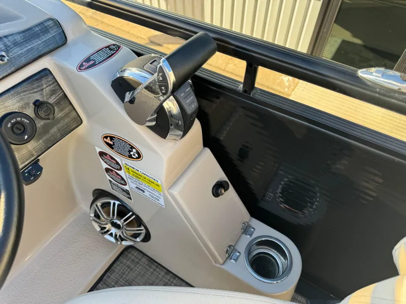 Slide: The Image of Control panel of 2018 Harris Solstice 240 boat with throttle and cup holder. - 19