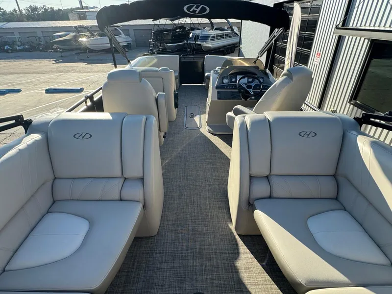 Slide: The Image of 2018 Harris Solstice 240 pontoon boat interior with plush seating and steering console. - 24