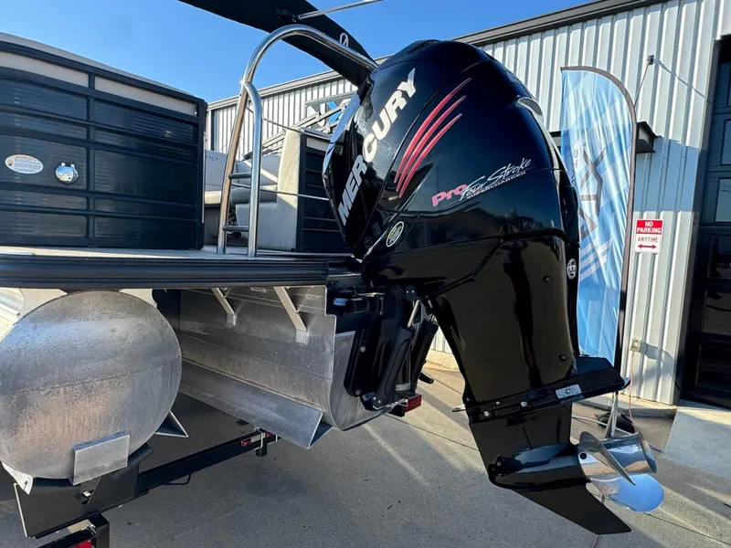 Slide: The Image of 2018 Harris Solstice 240 pontoon boat with Mercury outboard motor, docked near a building. - 4