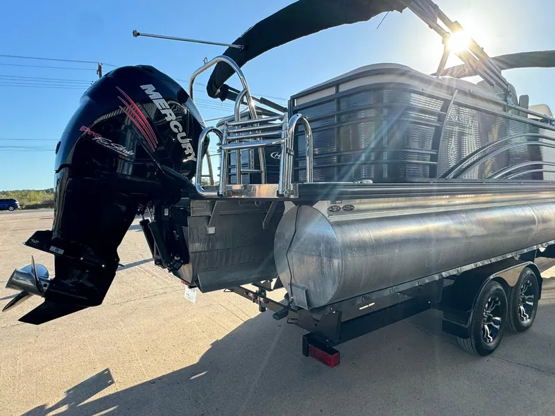 Slide: The Image of 2018 Harris Solstice 240 pontoon boat with Mercury outboard engine, parked on a trailer. - 5