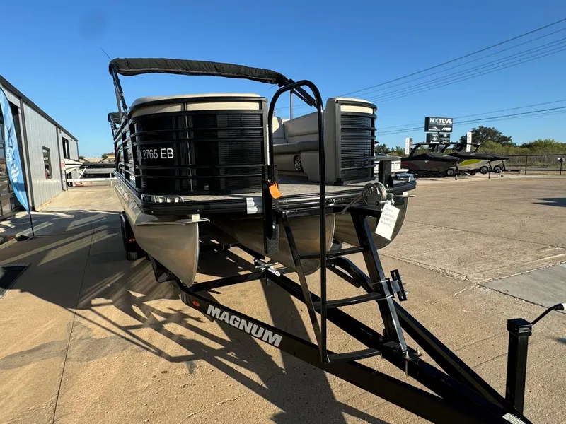 Slide: The Image of 2018 Harris Solstice 240 pontoon boat on a trailer in a sunny outdoor setting. - 7