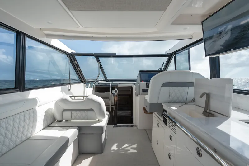 Slide: The Image of Luxurious interior of 2022 Regal 36 XO yacht with modern seating and kitchenette. - 14
