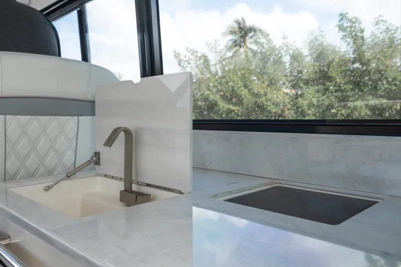 Slide: The Image of Modern kitchen area in 2022 Regal 36 XO yacht with sleek sink and countertop. - 2