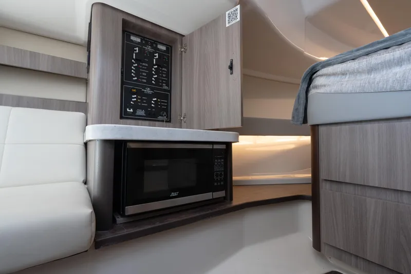 Slide: The Image of 2022 Regal 36 XO cabin interior with microwave and control panel. - 24