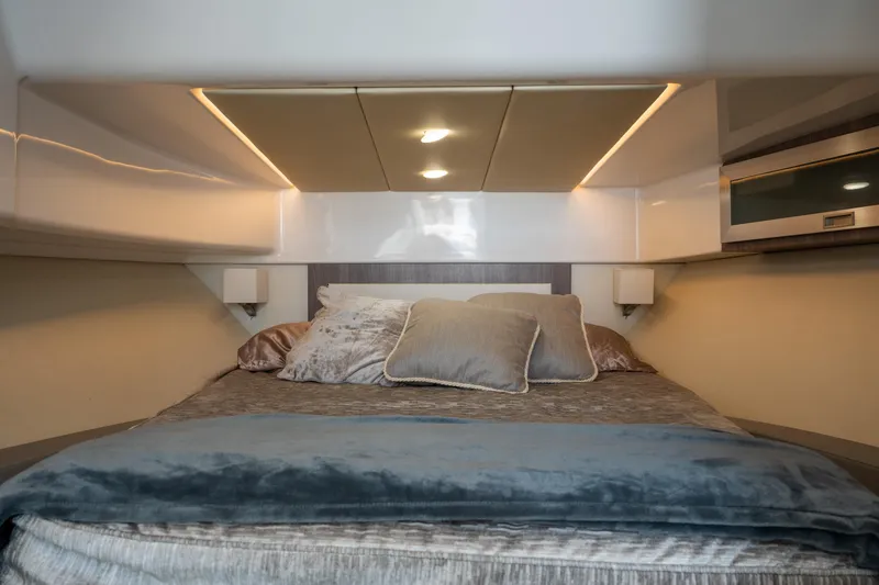 Slide: The Image of Luxurious cabin interior of 2022 Regal 36 XO yacht with cozy bedding. - 25