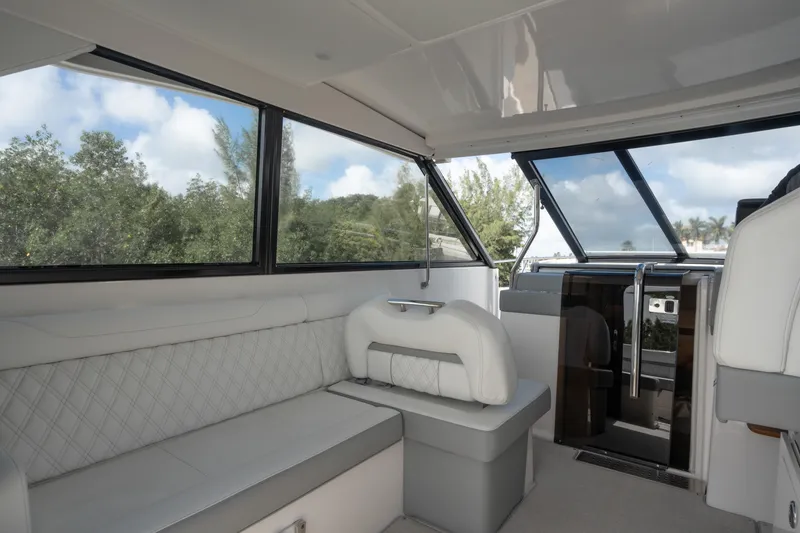 Slide: The Image of Interior of 2022 Regal 36 XO yacht with plush seating and large windows. - 3