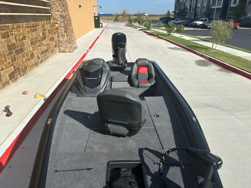 Slide: The Image of 2025 Tracker Pro Team 190 boat displayed indoors with Mercury Pro XS engine. - 3