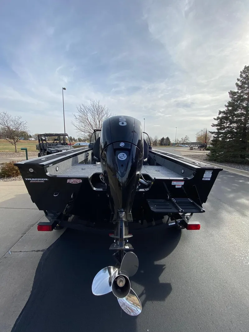 Slide: The Image of 2025 Tracker Targa V-18 WT boat with powerful outboard motor, parked outdoors. - 2