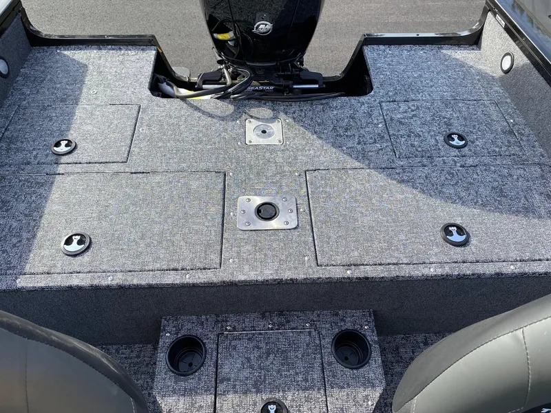 Slide: The Image of 2025 Tracker Targa V-18 WT boat interior with carpeted deck and storage compartments. - 5
