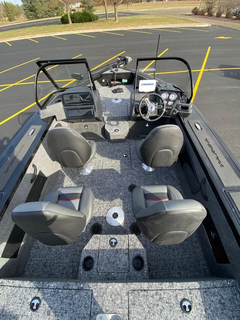 Slide: The Image of 2025 Tracker Targa V-18 WT boat interior with four seats and modern dashboard. - 6