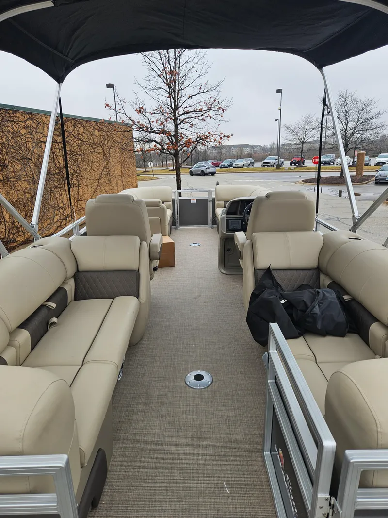 Slide: The Image of 2025 Sun Tracker Party Barge 22 DLX pontoon boat with beige seating and canopy. - 3