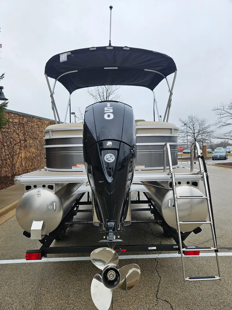 Slide: The Image of 2025 Sun Tracker Party Barge 22 DLX pontoon boat with outboard motor and ladder. - 5