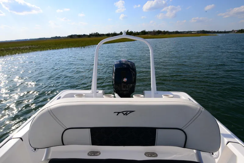 Slide: The Image of Tidewater 2110 Bay Max 2022 boat on serene water with clear sky. - 23