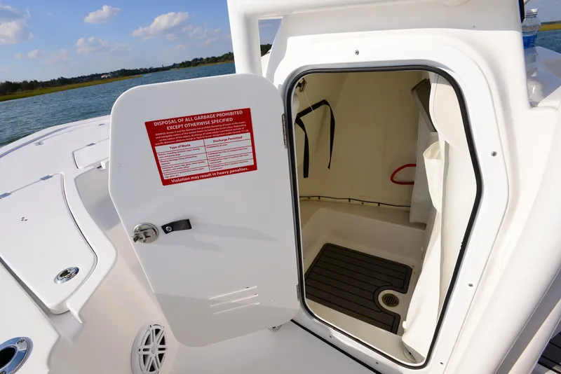 Slide: The Image of 2022 Tidewater 2110 Bay Max boat with open storage compartment on deck. - 27