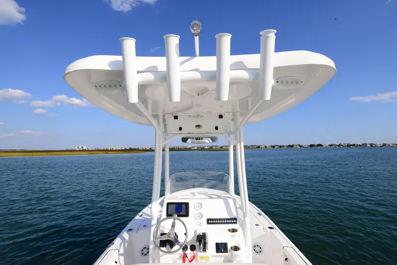 Slide: The Image of 2022 Tidewater 2110 Bay Max boat on calm water under clear blue sky. - 28