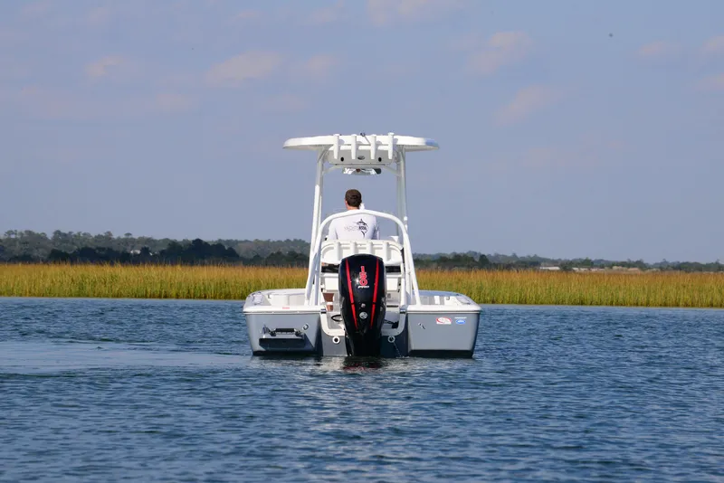Slide: The Image of 2022 Tidewater 2110 Bay Max boat cruising on a calm waterway. - 8