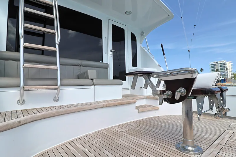 Slide: The Image of 2004 Hatteras 54 Convertible yacht deck with seating and fishing equipment. - 10