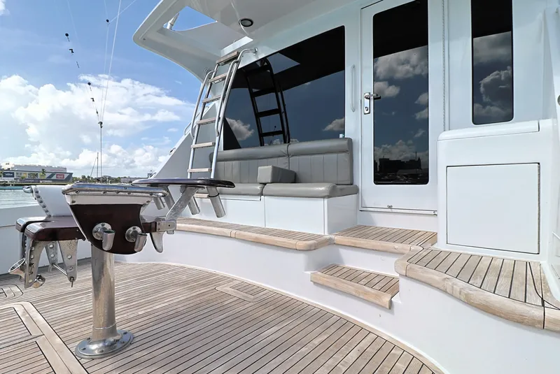 Slide: The Image of 2004 Hatteras 54 Convertible yacht deck with seating, ladder, and fishing equipment. - 11
