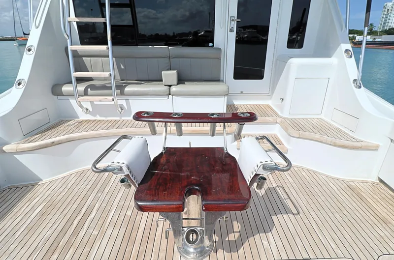 Slide: The Image of 2004 Hatteras 54 Convertible yacht deck with seating and fishing chair. - 13