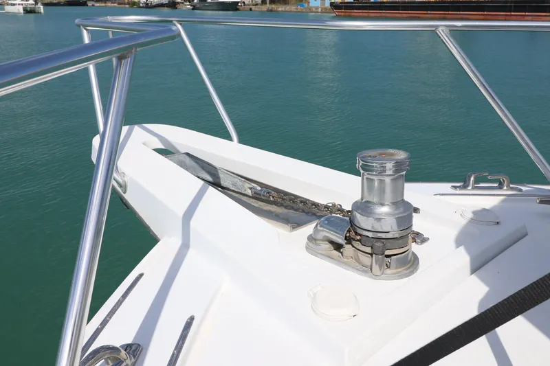 Slide: The Image of Bow of 2004 Hatteras 54 Convertible yacht with anchor winch in marina. - 19
