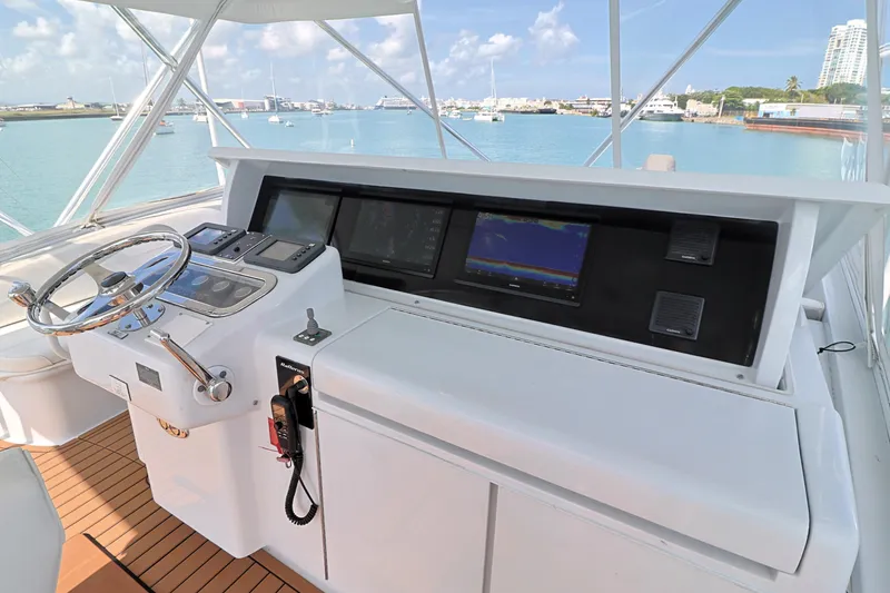 Slide: The Image of Helm of 2004 Hatteras 54 Convertible yacht with navigation equipment and ocean view. - 22