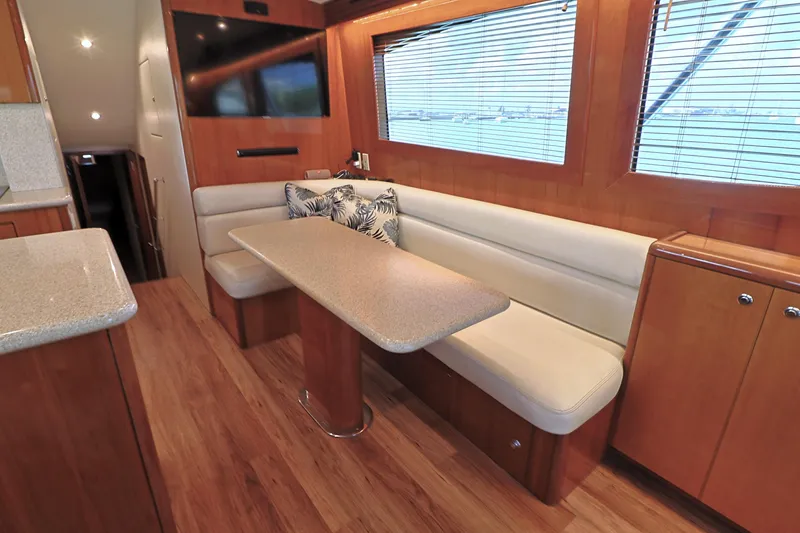 Slide: The Image of Luxurious interior of 2004 Hatteras 54 Convertible yacht with elegant dining area. - 28