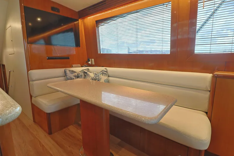 Slide: The Image of Interior of 2004 Hatteras 54 Convertible yacht with dining area and TV. - 29