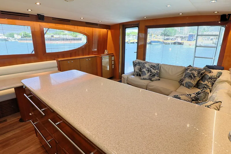 Slide: The Image of Luxurious interior of 2004 Hatteras 54 Convertible yacht with modern furnishings and waterfront view. - 31