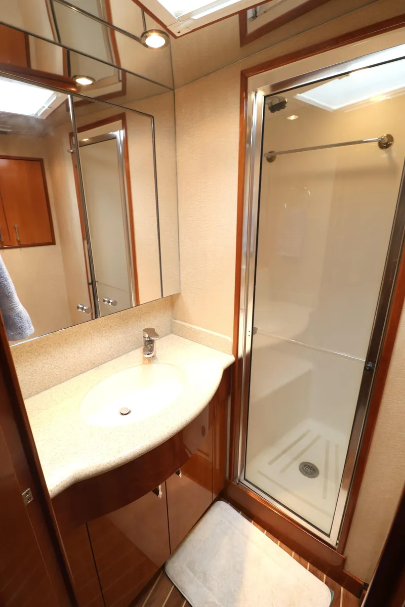 Slide: The Image of 2004 Hatteras 54 Convertible yacht bathroom with shower and vanity. - 38