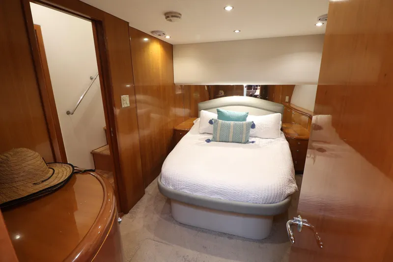Slide: The Image of Luxurious cabin interior of 2004 Hatteras 54 Convertible yacht with cozy bed and wooden finish. - 41