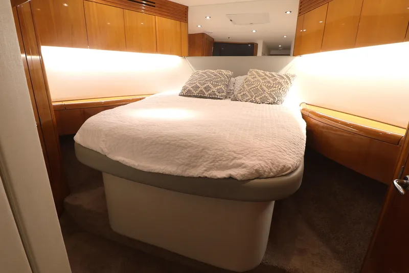 Slide: The Image of Luxurious bedroom interior of 2004 Hatteras 54 Convertible yacht with cozy bedding. - 42