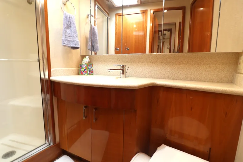 Slide: The Image of Luxurious bathroom in 2004 Hatteras 54 Convertible yacht with wooden cabinetry and modern fixtures. - 47