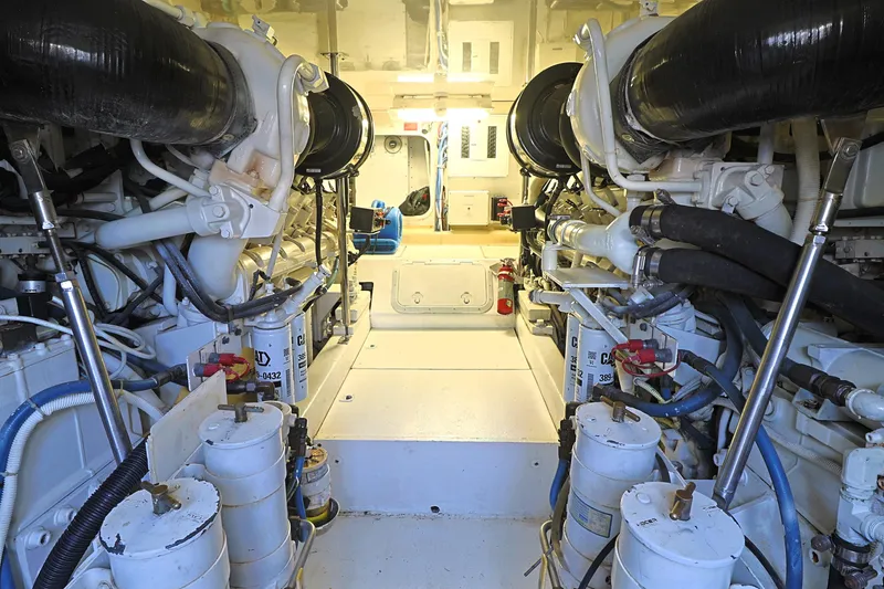 Slide: The Image of Engine room of 2004 Hatteras 54 Convertible yacht, showcasing dual engines and mechanical systems. - 48