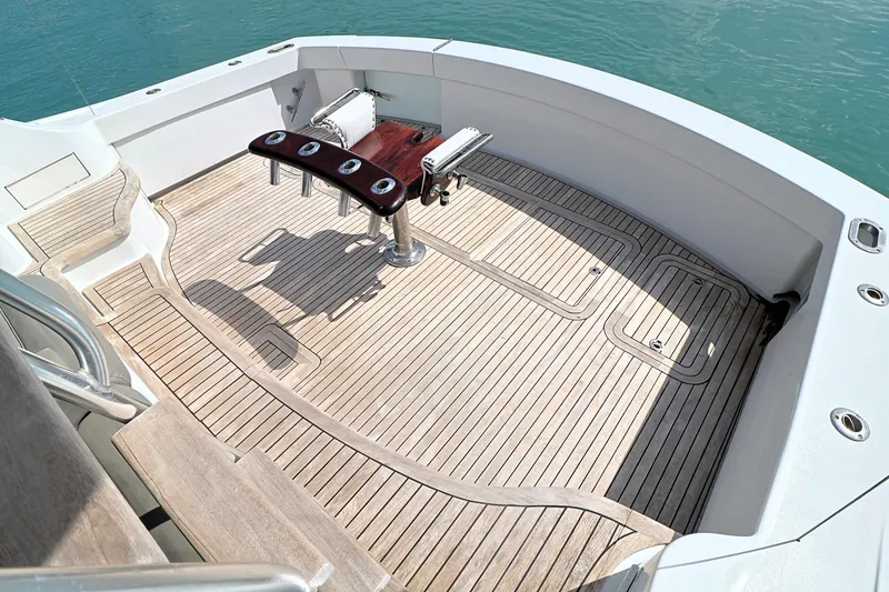 Slide: The Image of 2004 Hatteras 54 Convertible yacht deck with fishing chair and rod holders. - 9